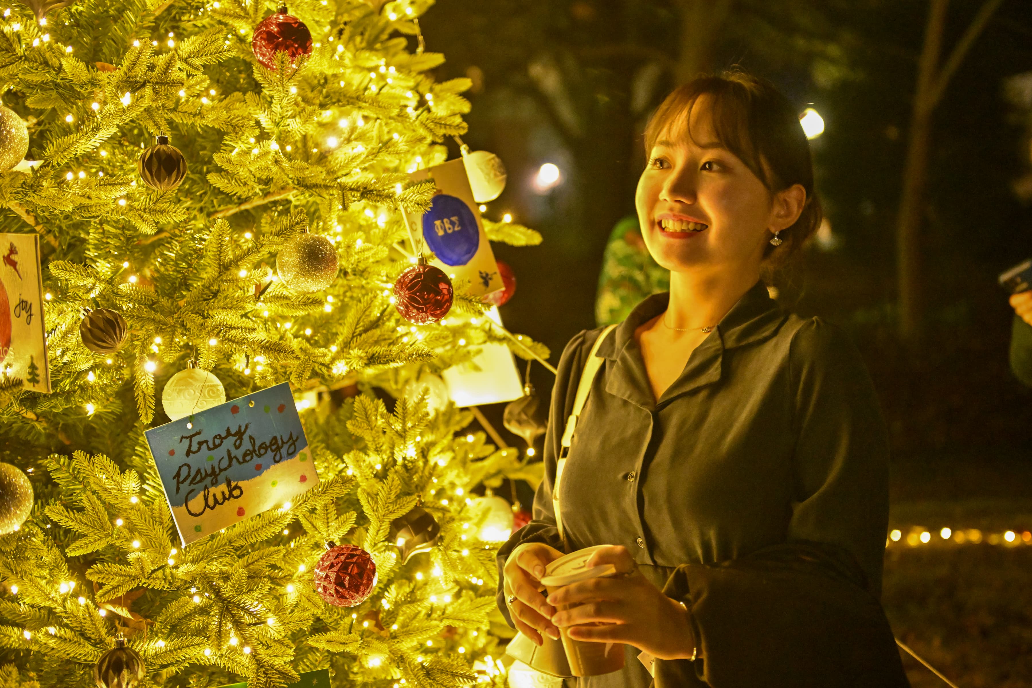 Student in front of Christmas Tree