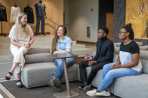School of Social Work and Human Services professor talking with students in Jones Hall lobby
