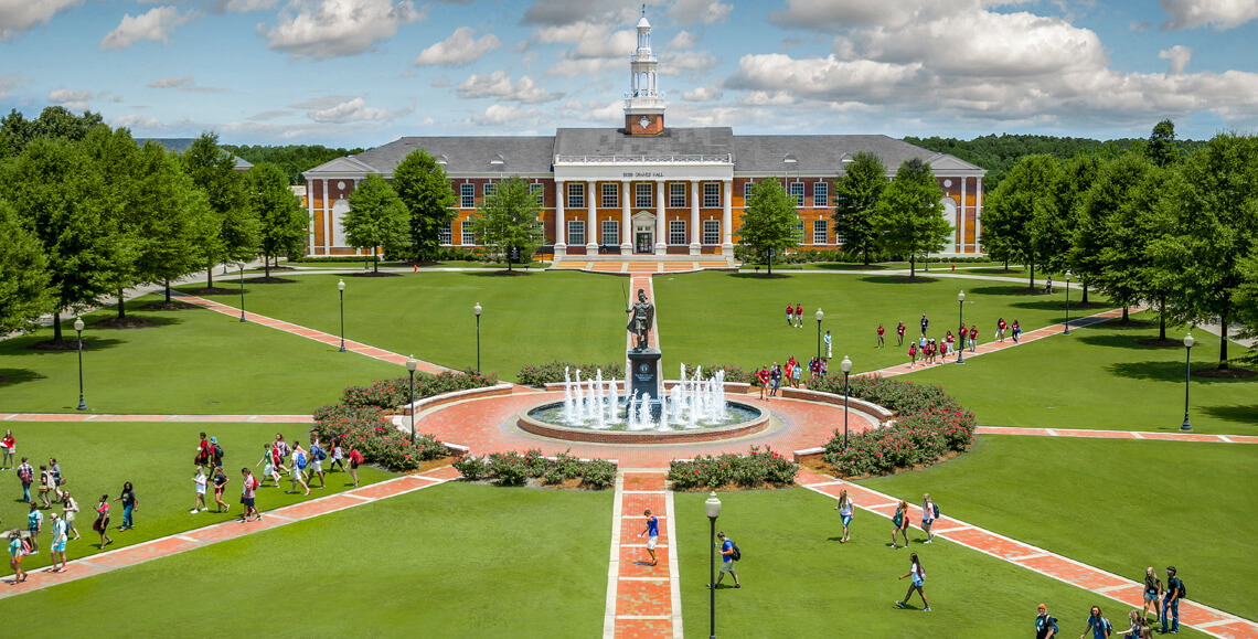 Student walking on the main quad on the Troy, AL campus.