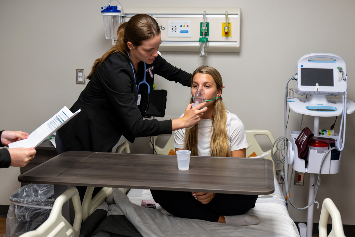 Nursing student practicing during simulation event. 