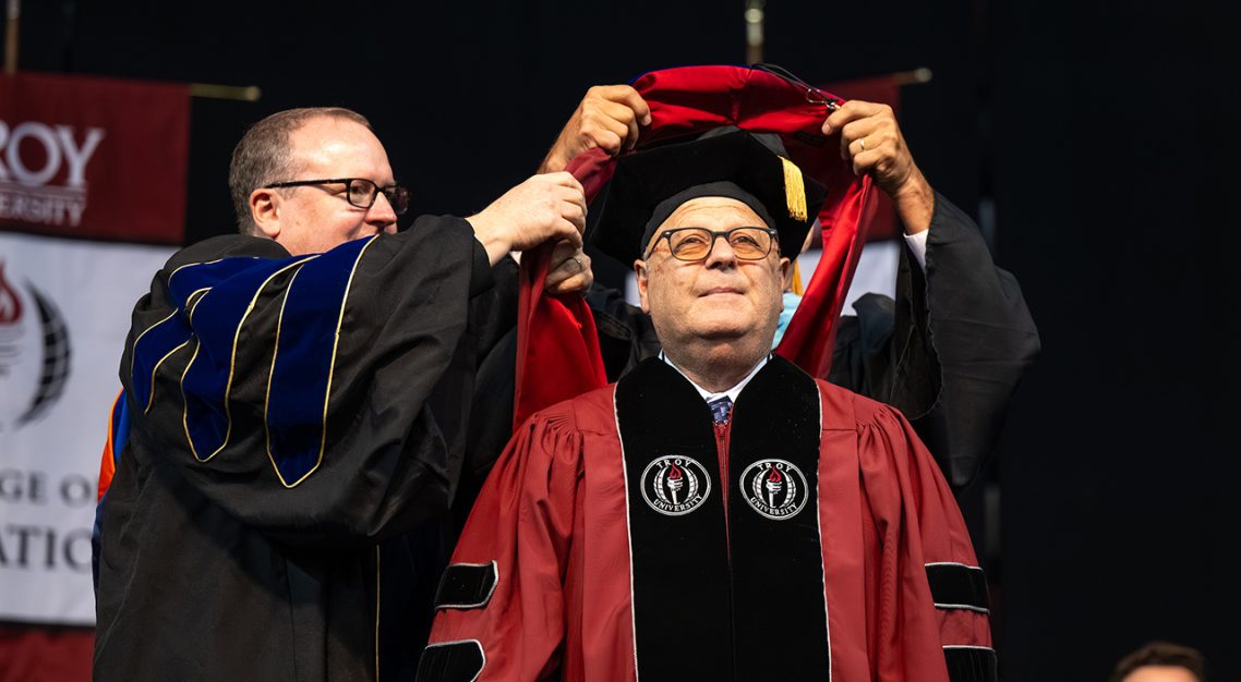 Arthur Abruzzo is hooded at the 2025 summer commencement ceremony.