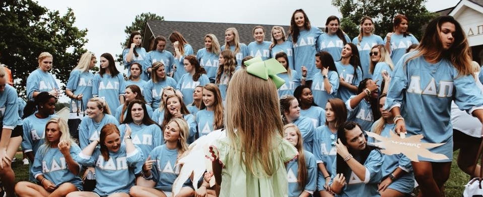 Little girl in front of Alpha Delta Pi sisters at Troy University