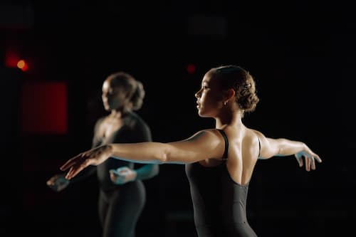Dancers performing on stage in a lift position