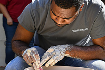 young artist working with pottery