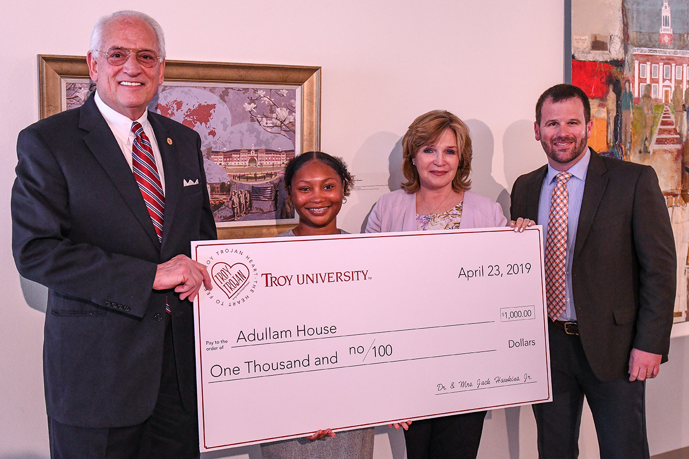Dr. Jack Hawkins, Jr., Mrs. Janice Hawkins and Jonathan Cellon present Jasmine Denson with a $1,000 donation to the charity of her choosing, Adullam House in Wetumpka.