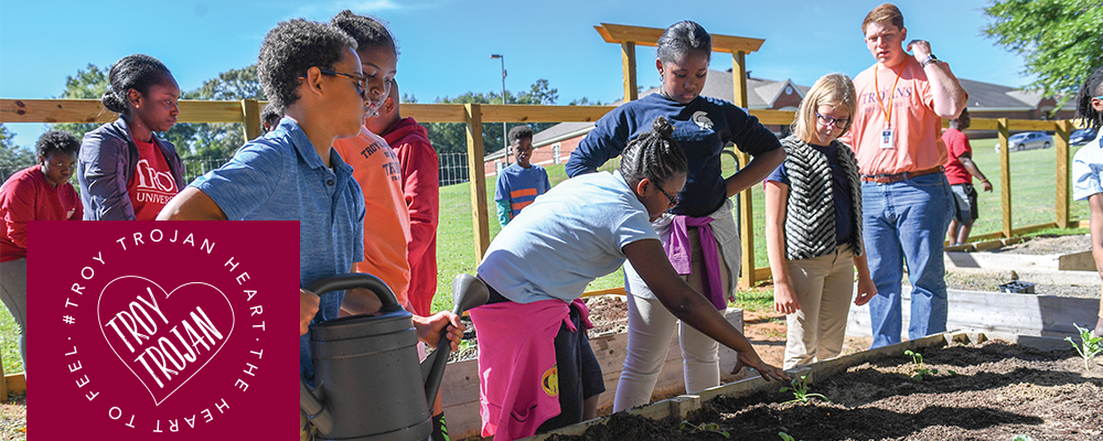TROY trojan heart, the heart to fell, over faculty and students on project planting plants.