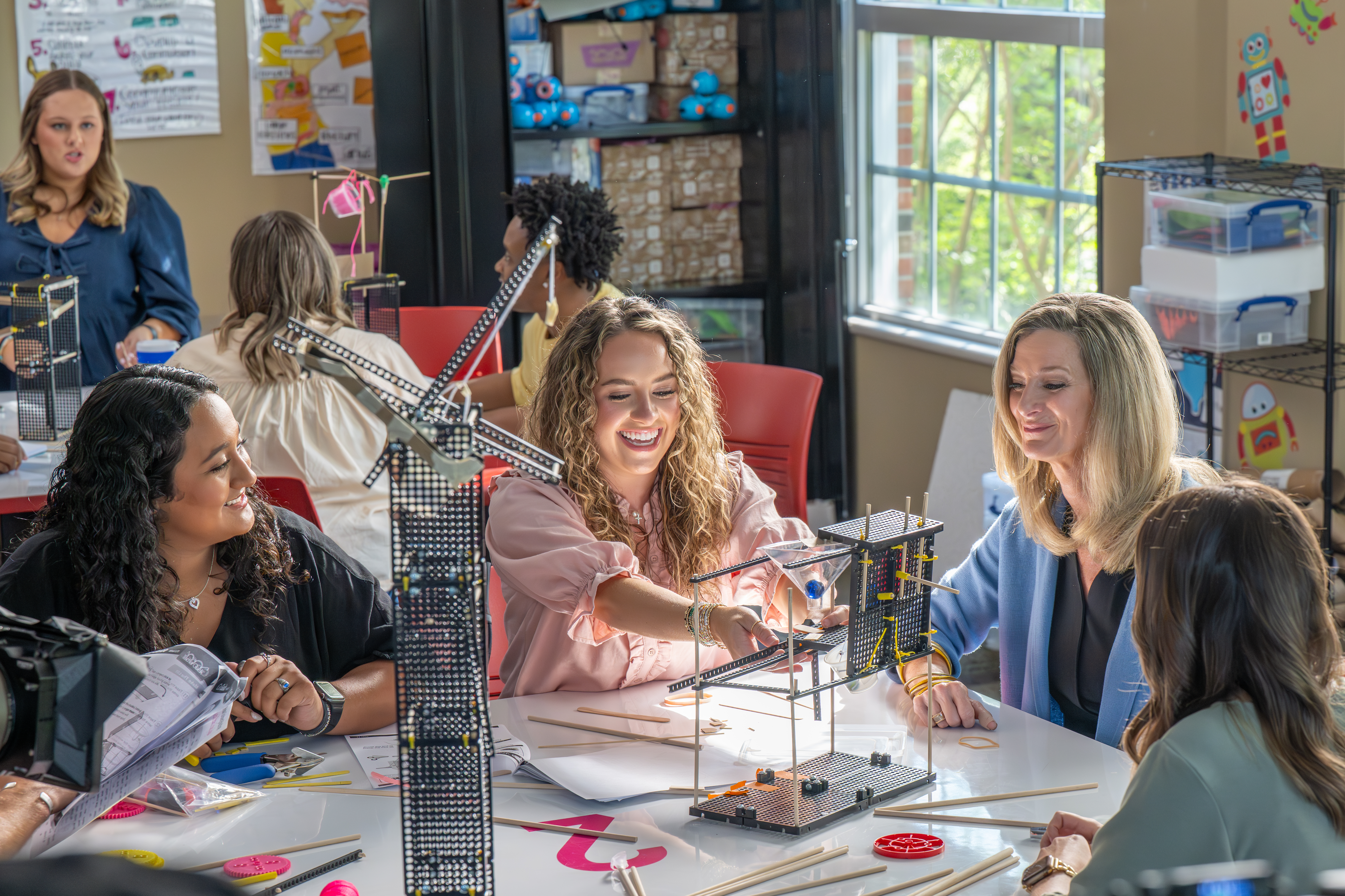 Students working together on a project under the professor's supervision