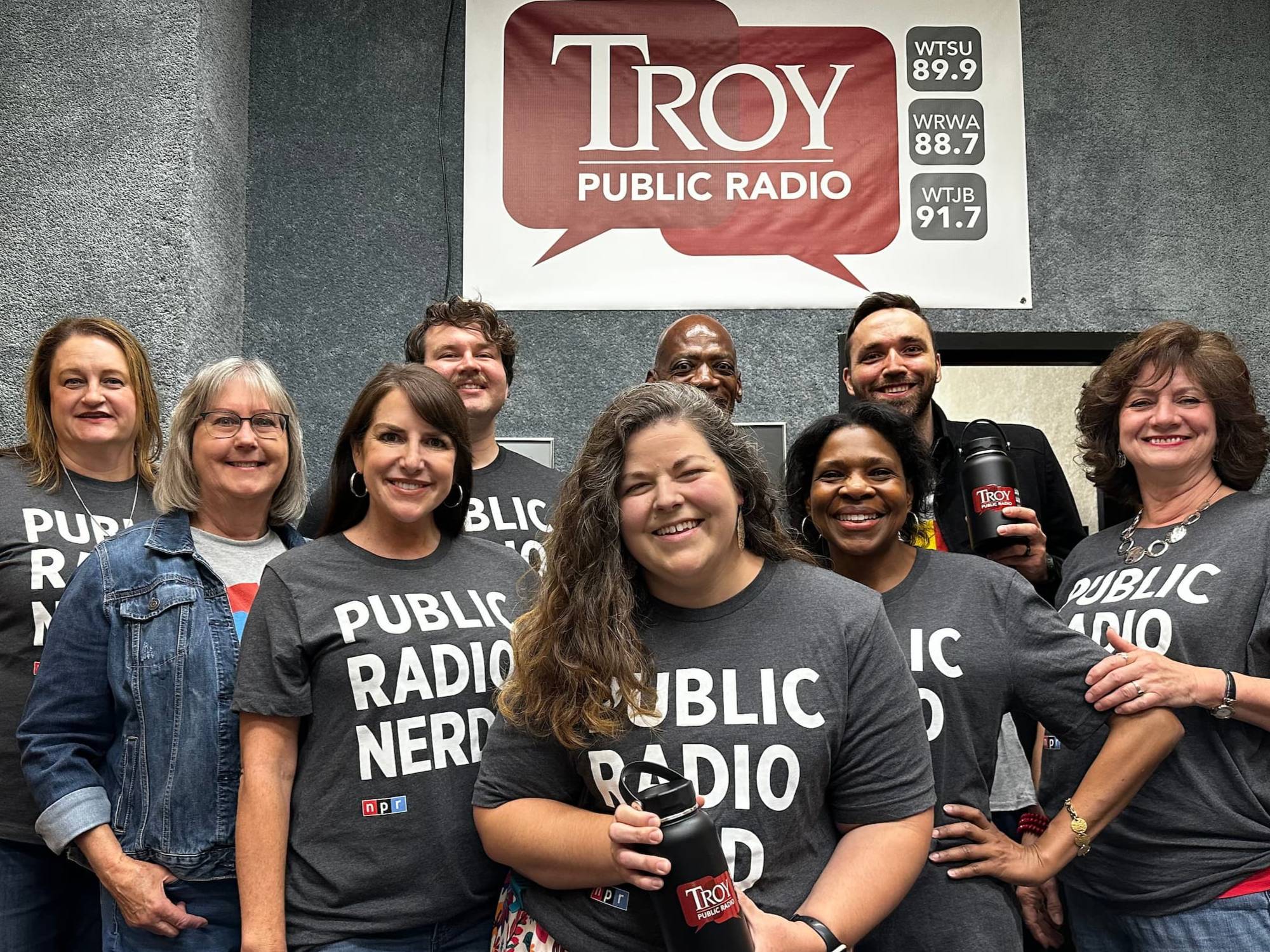 Group of on-air personalities wearing the Public Radio nerd tshirt