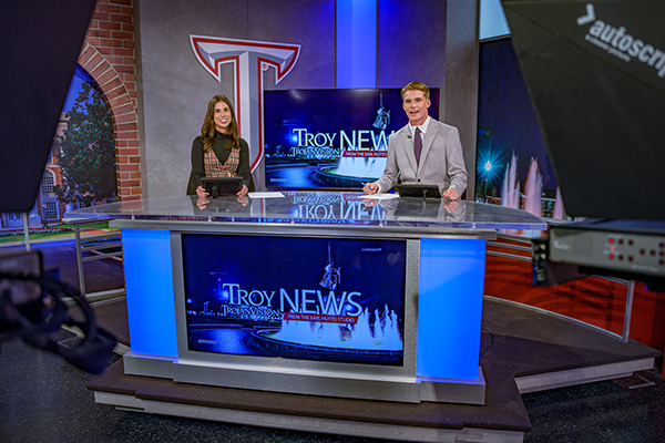 Paige Ray and her student in the studion guiding the camera