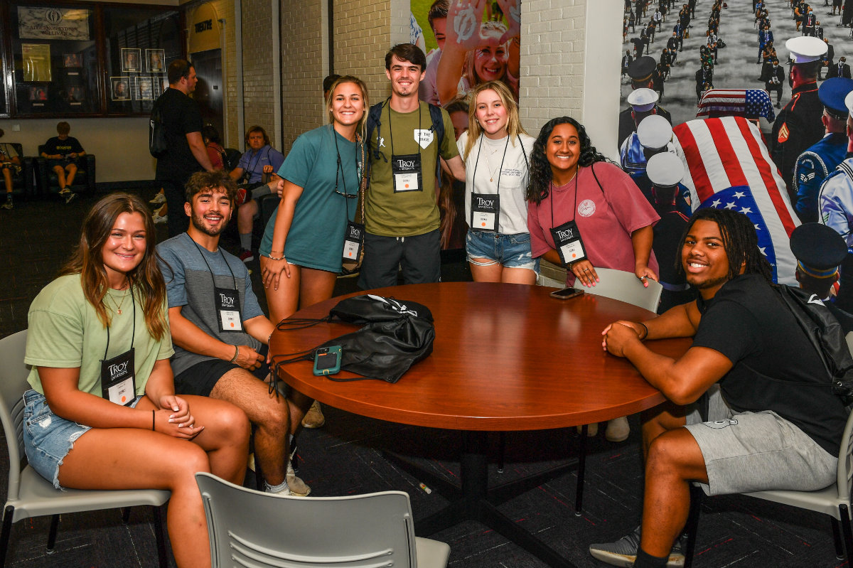 Students gathered around table during Impact New Student Orientation